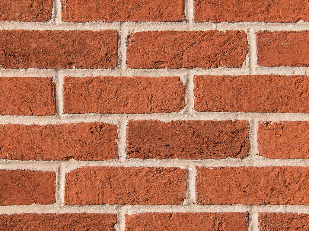 Close up of a wall of Orange Village Handmade bricks