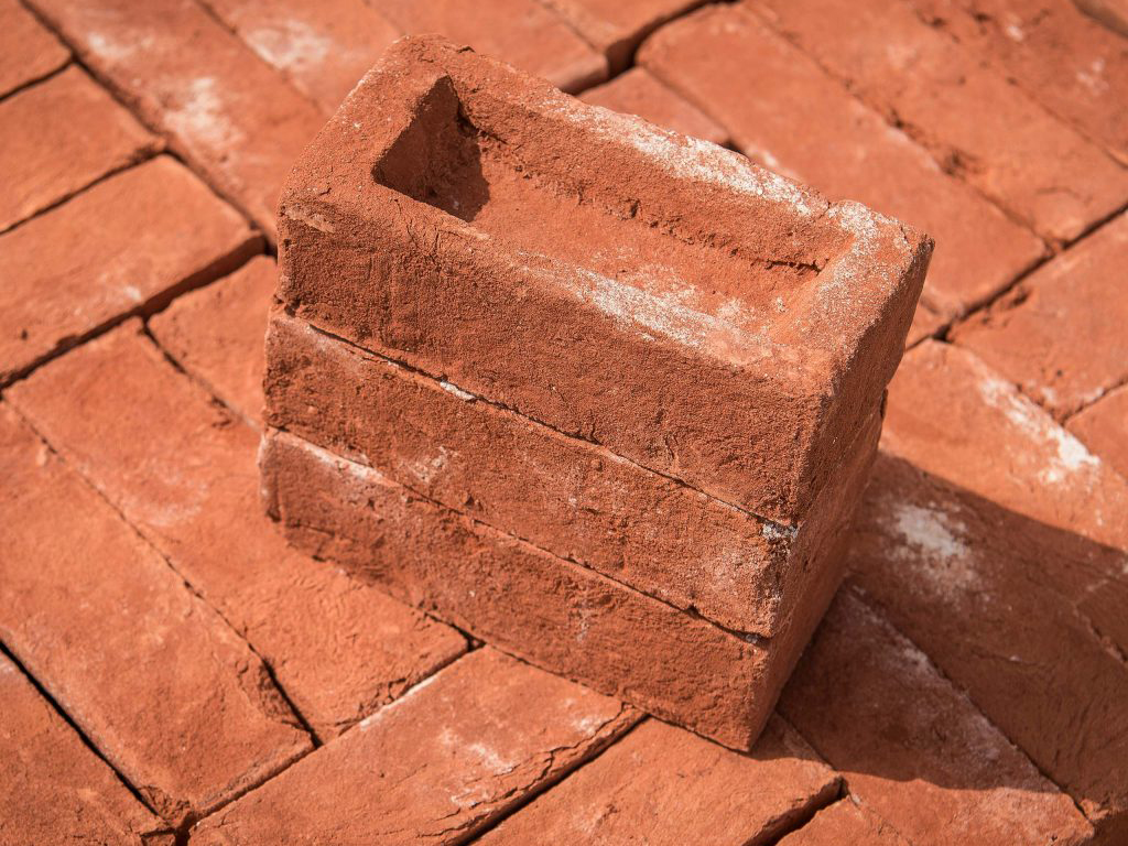 A stack of Oasthouse Orange Handmade bricks