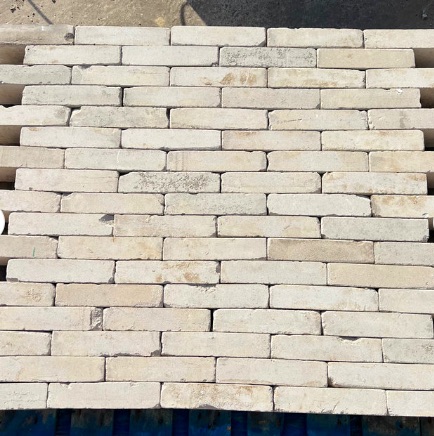 view of full panel of white linear bricks on a pallet