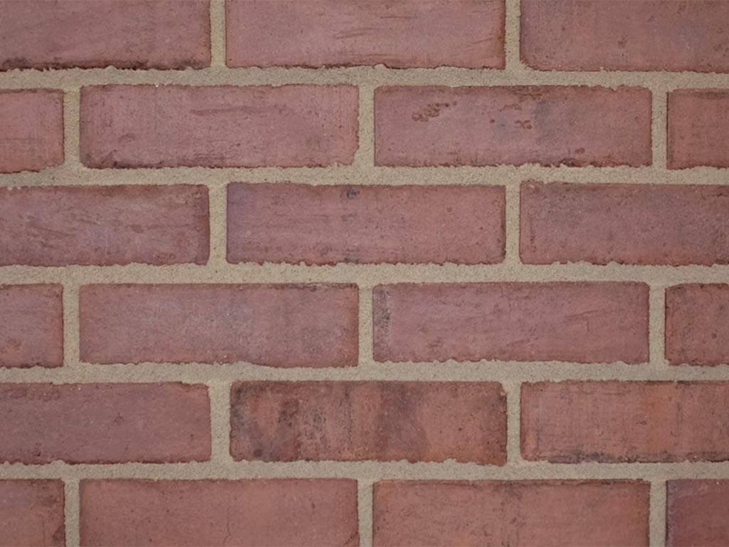 Close up of a wall of Old Victorian Pressed Weathered bricks