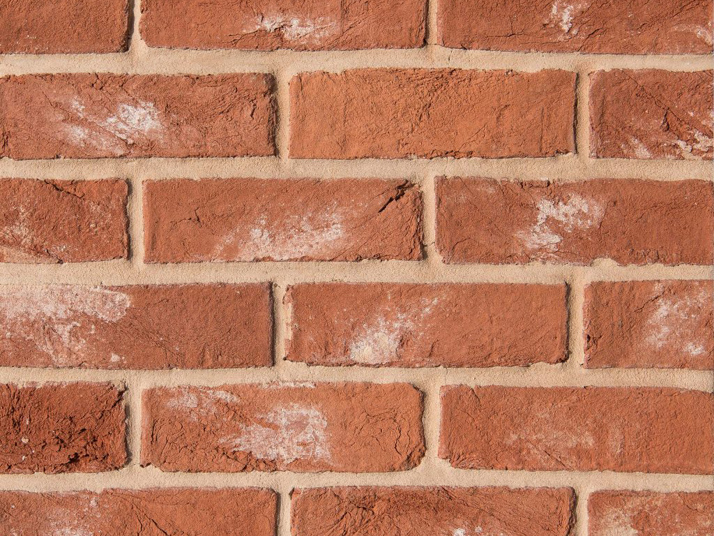 Close up of a wall of Oasthouse Orange Handmade bricks