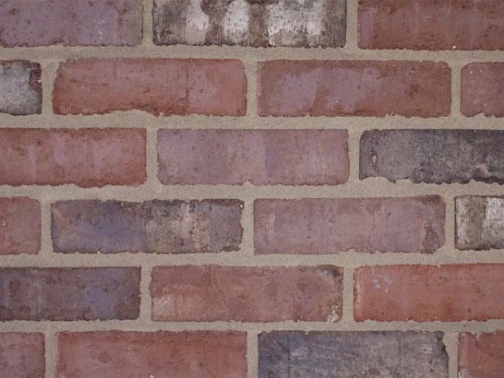 Close up of a wall of Burnt Ember bricks