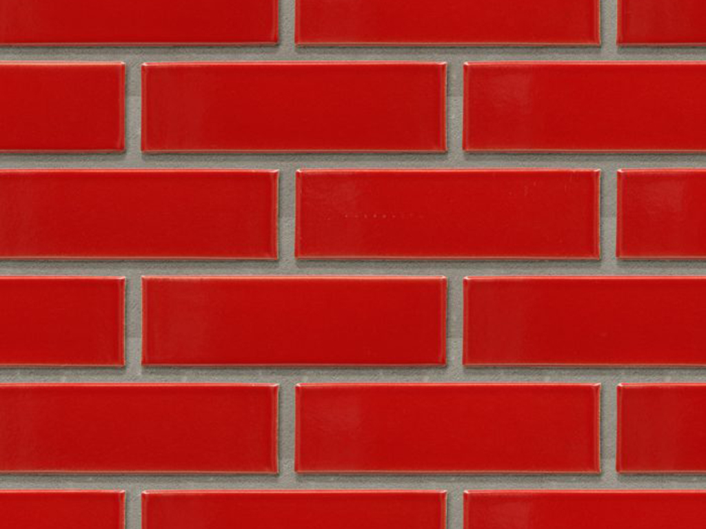 Close up of a wall of Madrid Red Glazed bricks