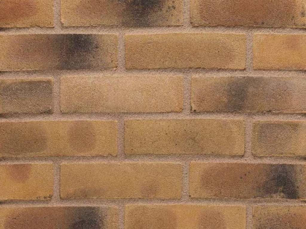 Close up of a wall of Smoked Yellow Multi Gilt Stock bricks