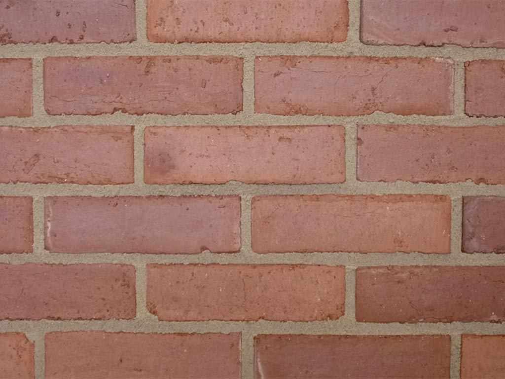 Close up of a wall of Old Victorian Pressed Medium Light bricks