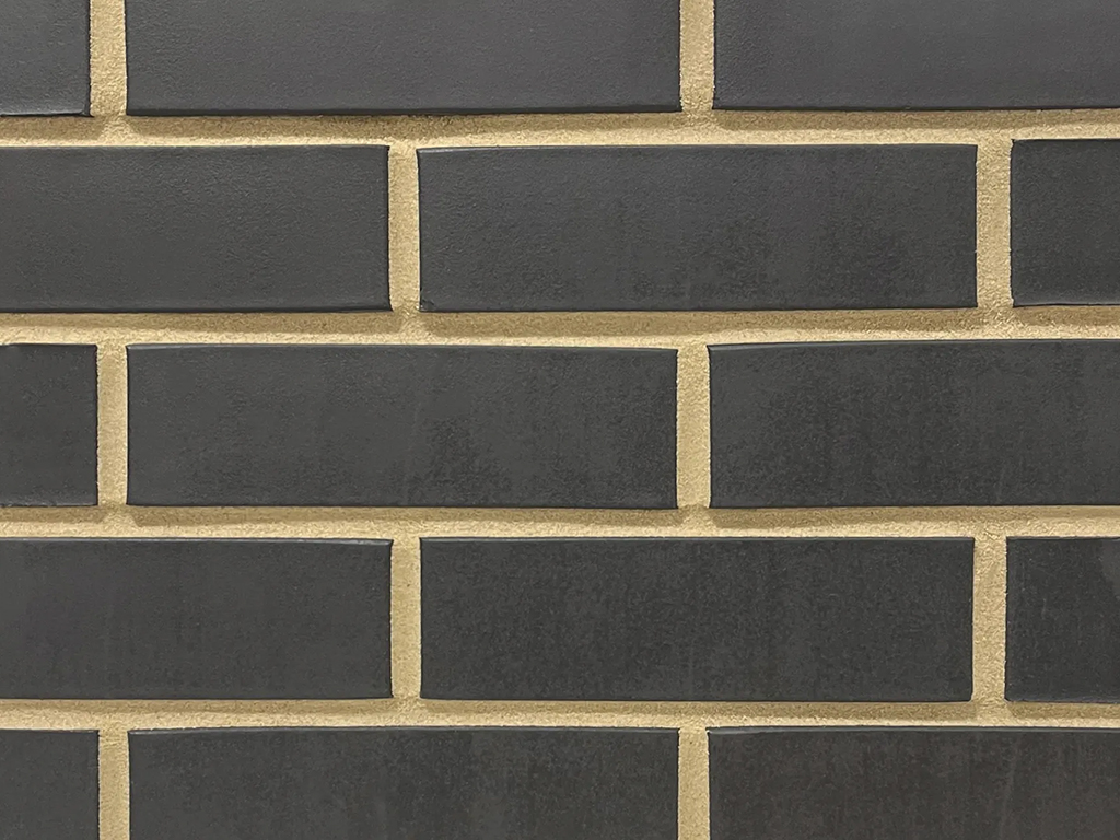 Close up of a wall of Black Smooth bricks