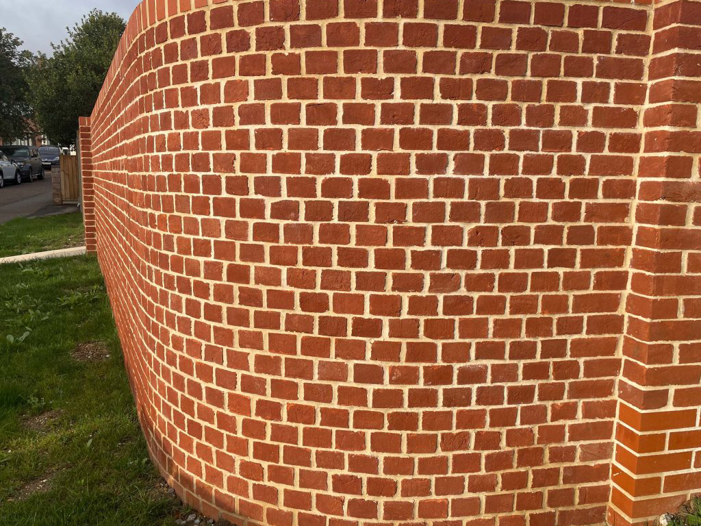 A garden wall built using Plumley Red Handmade bricks