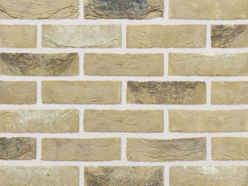 Close up of a wall of Weathered Buff Handmade bricks