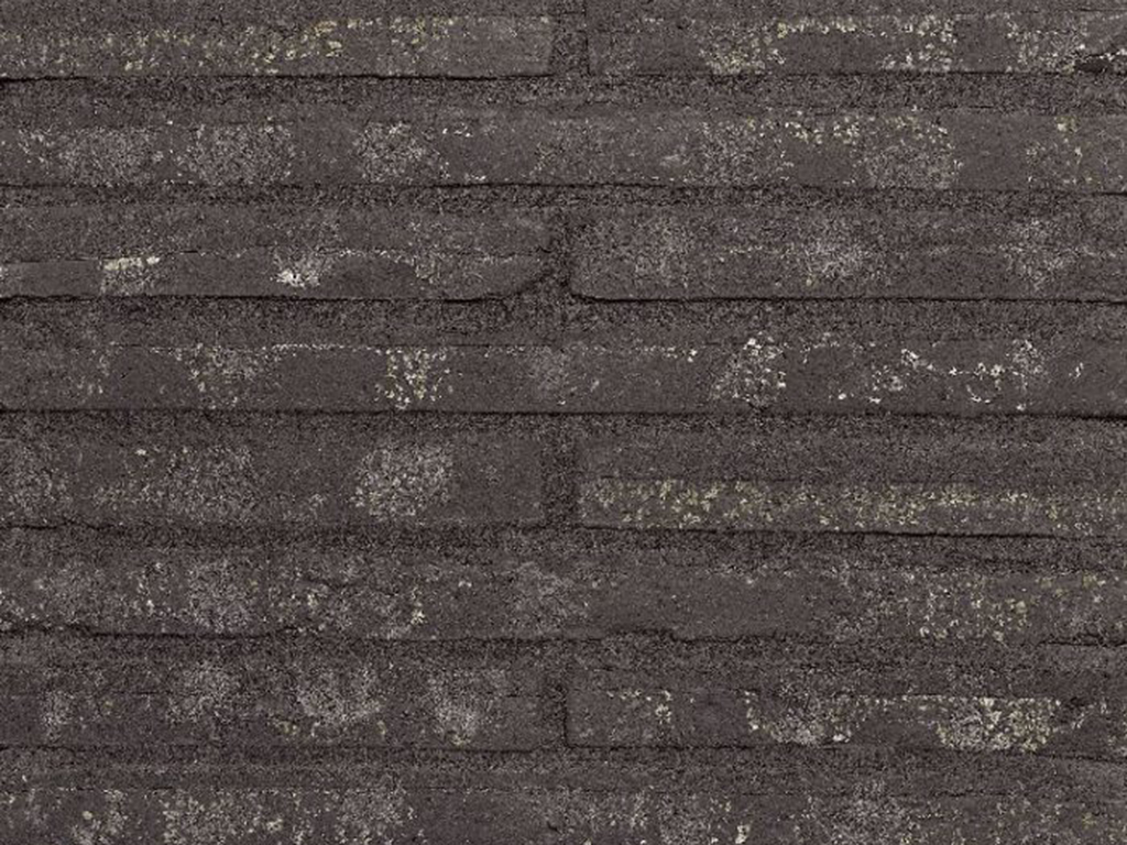 Close up of a wall of Roman Black Waterstruck bricks