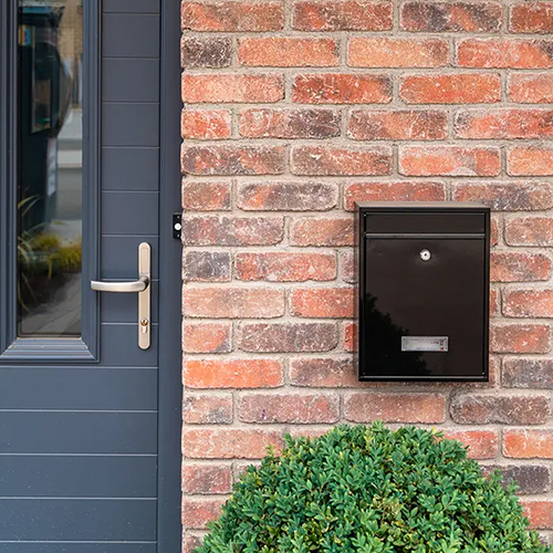 A postbox on a house built from Oldtown Multi Antique bricks