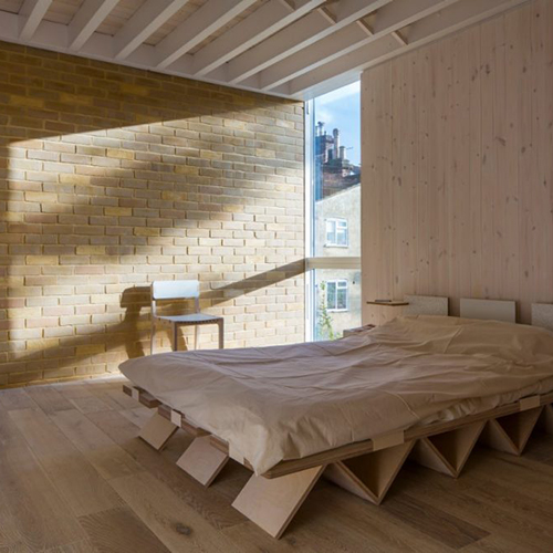 A Sheerwater Silver Yellow interior feature wall in a bedroom