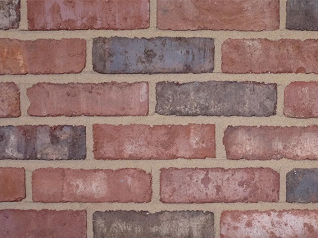 Close up of a wall of Clamp Pressed Weathered Red bricks