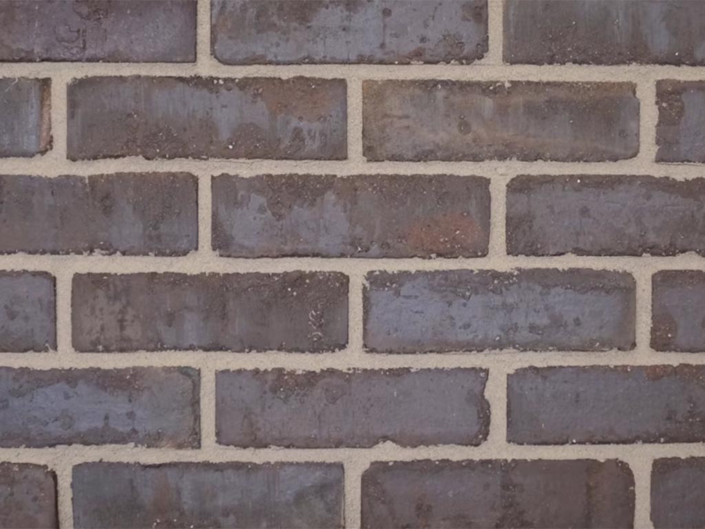 CLose up of a wall of Clamp Plain Black bricks