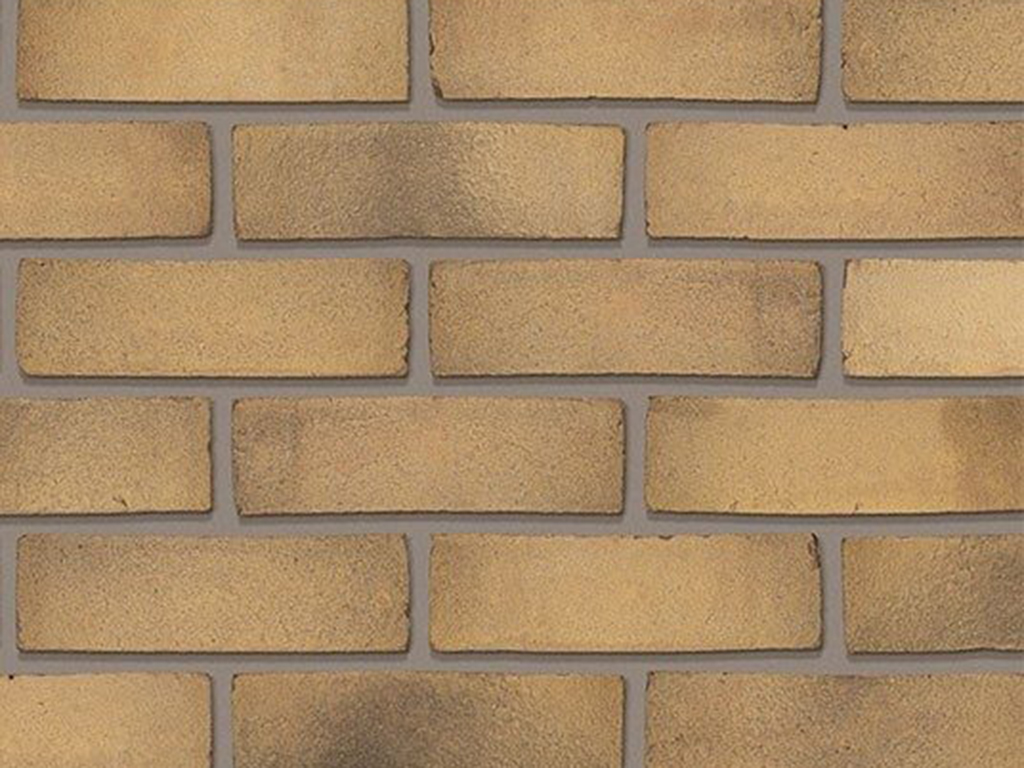 Close up of a wall of Trinity Cream Multi Gilt Stock bricks