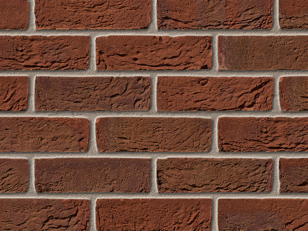 Close up of a wall of Bradgate Claret bricks