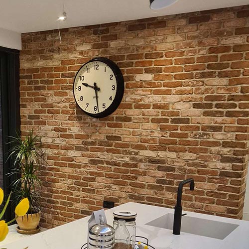 A wall of Whitby Red Multi brick slips in a modern kitchen