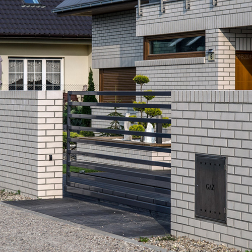 A boundary wall built from Oslo Pearl and White Smooth bricks