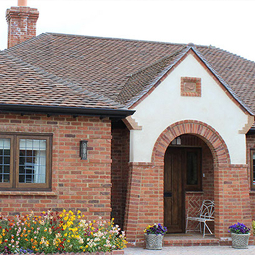 An exterior of a house built using Handmade Assorted Reclaim bricks