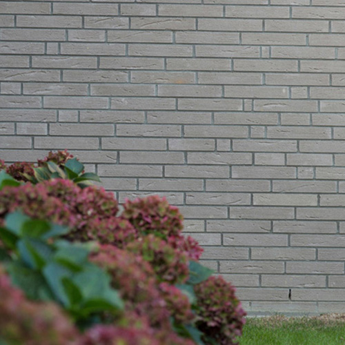 A garden with Fort Grey bricks in the background