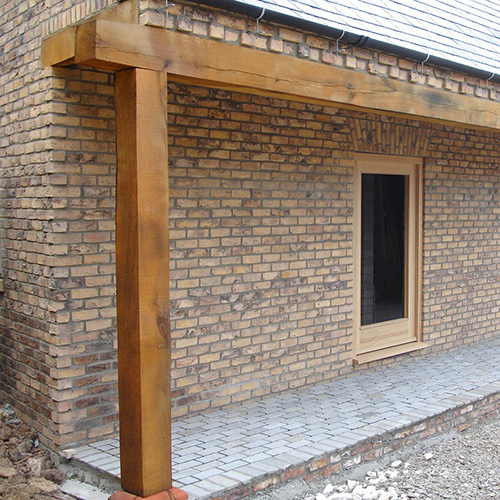 A garden with Kilburn bricks in the background