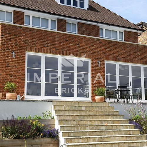 An exterior of a house built using Reclamation Weathered Soft Red bricks