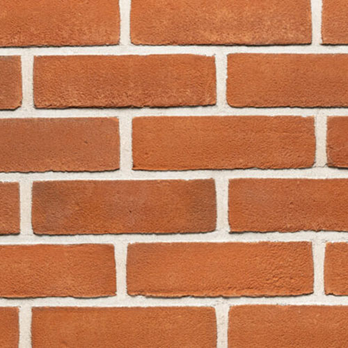 Close up of a wall of Woodcroft Orange Stock bricks