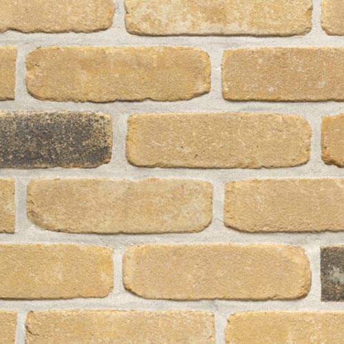Close up of a wall of Lutterworth Weathered Cream bricks