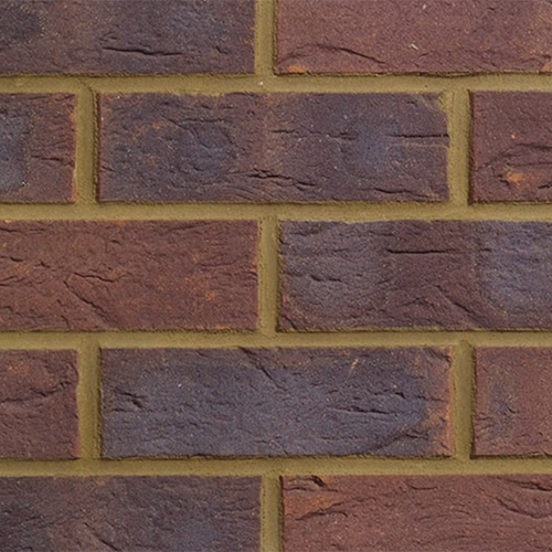 Close up of a wall of Village Russet Red Mixture bricks