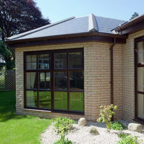 A garden with Andante Golden Buff bricks in the background