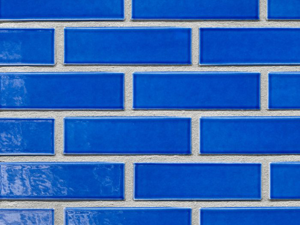 Close up of a wall of Oceania Dark Blue Glazed bricks