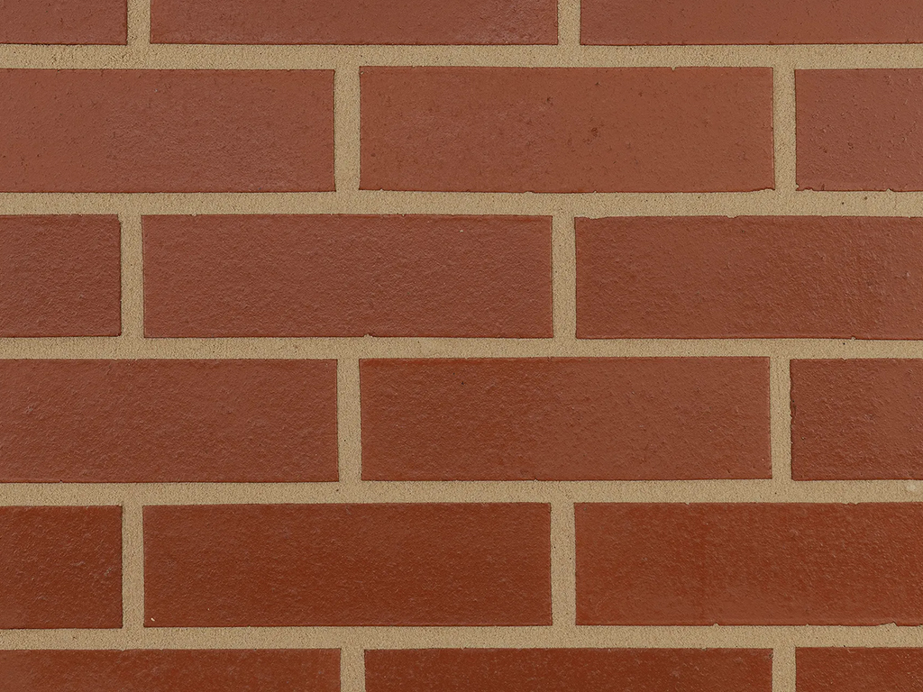 Close up of a wall of Smooth Red bricks