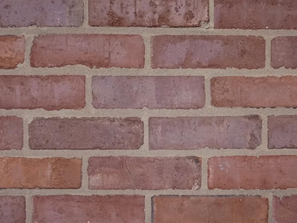 Close up of a wall of Clamp Natural Orange Medium Dark bricks