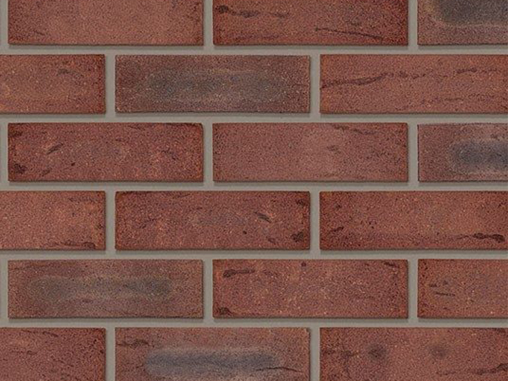 Close up of a wall of Tuscan Red Multi bricks