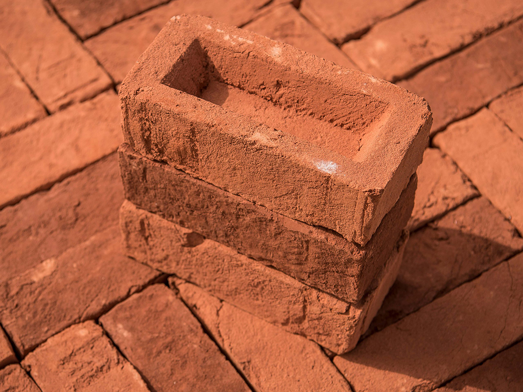 A stack of Orange Village Handmade bricks