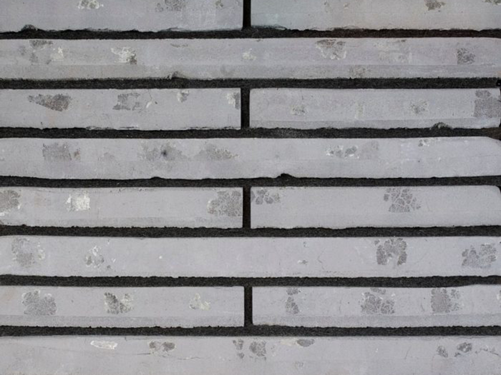 Close up of a wall of Roman Grey Waterstruck bricks