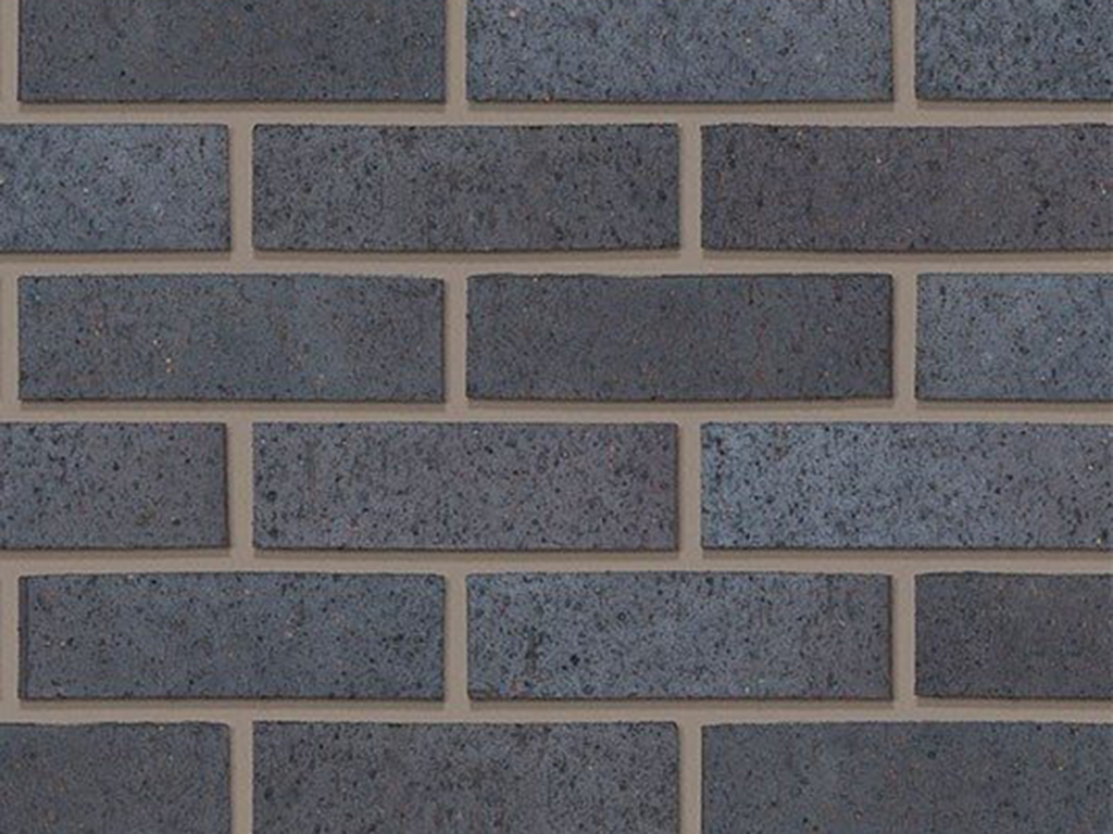 Close up of a wall of Staffordshire Blue Dragfaced bricks